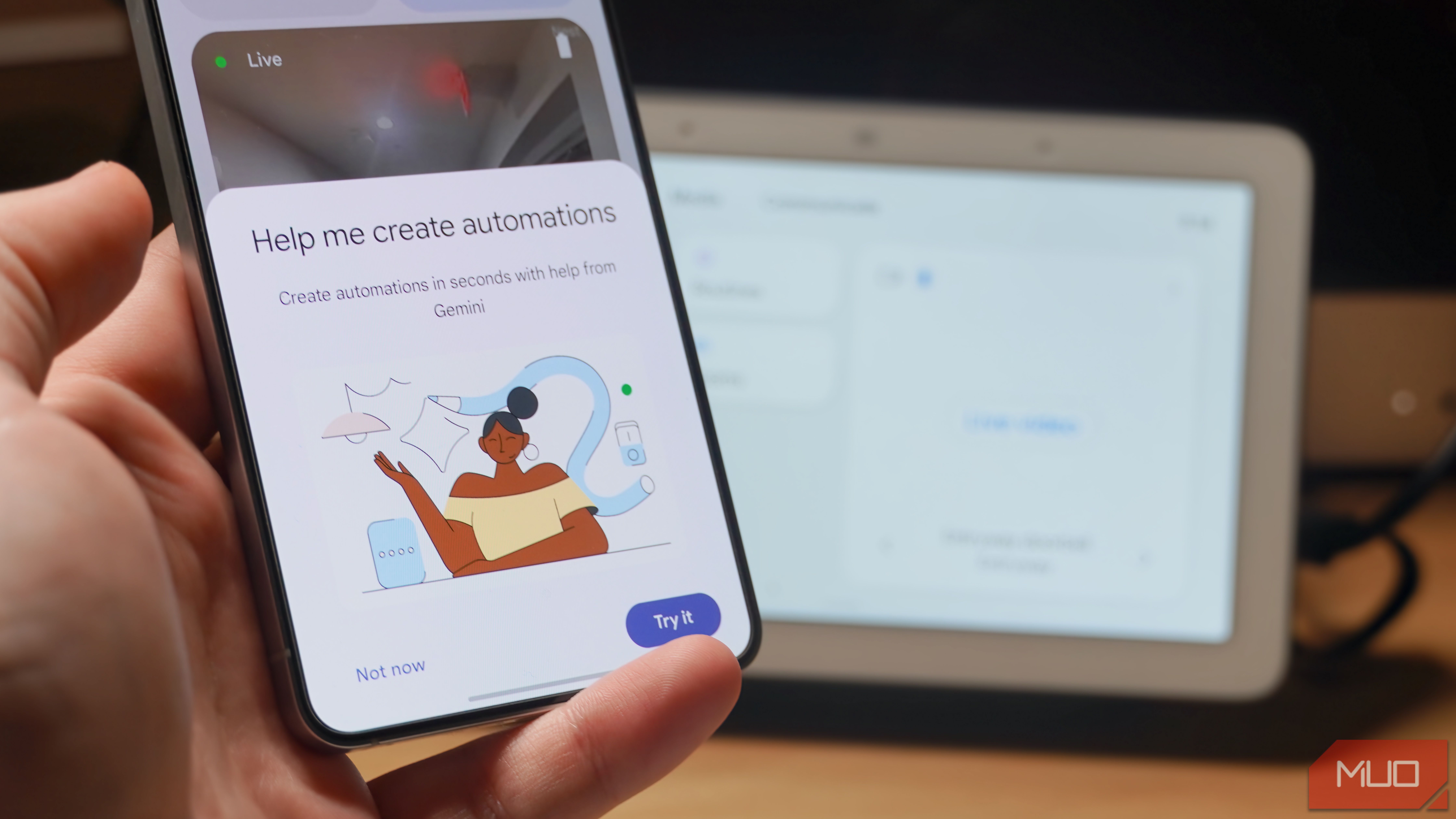 The Gemini Help Me Create feature on a phone with a Nest Hub Display in the background.
