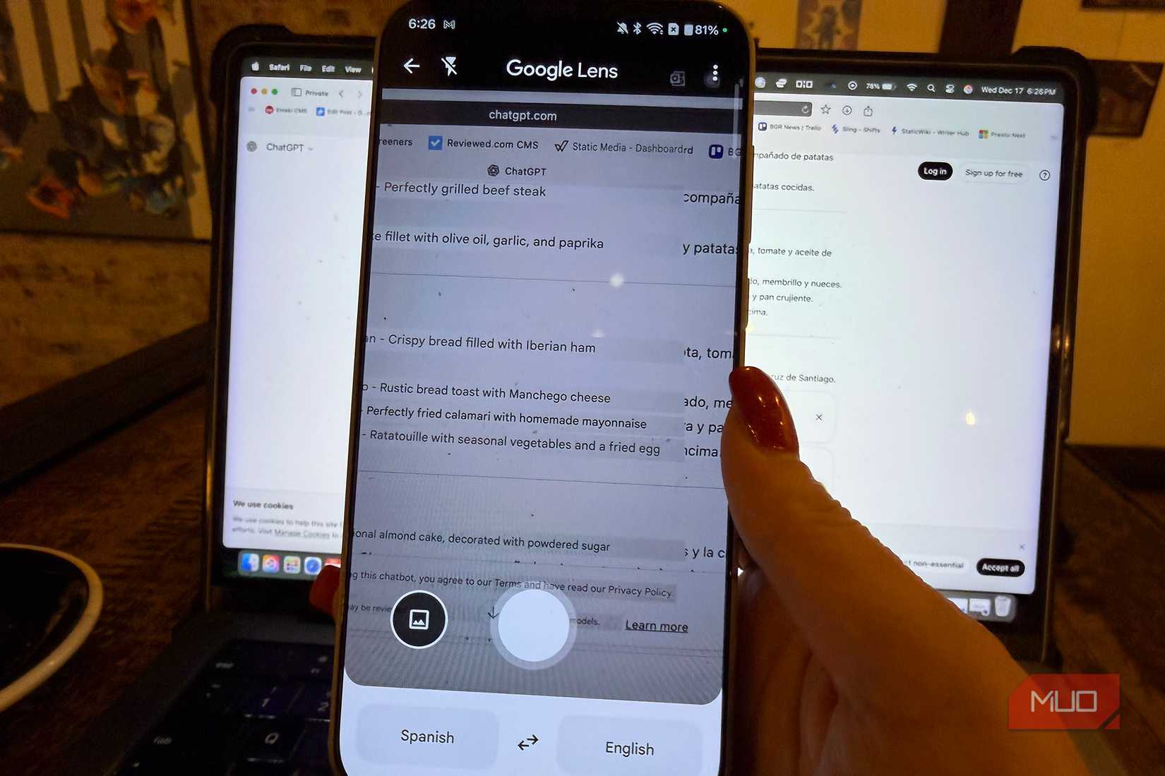 A phone with Google Lens open in front of a computer screen.