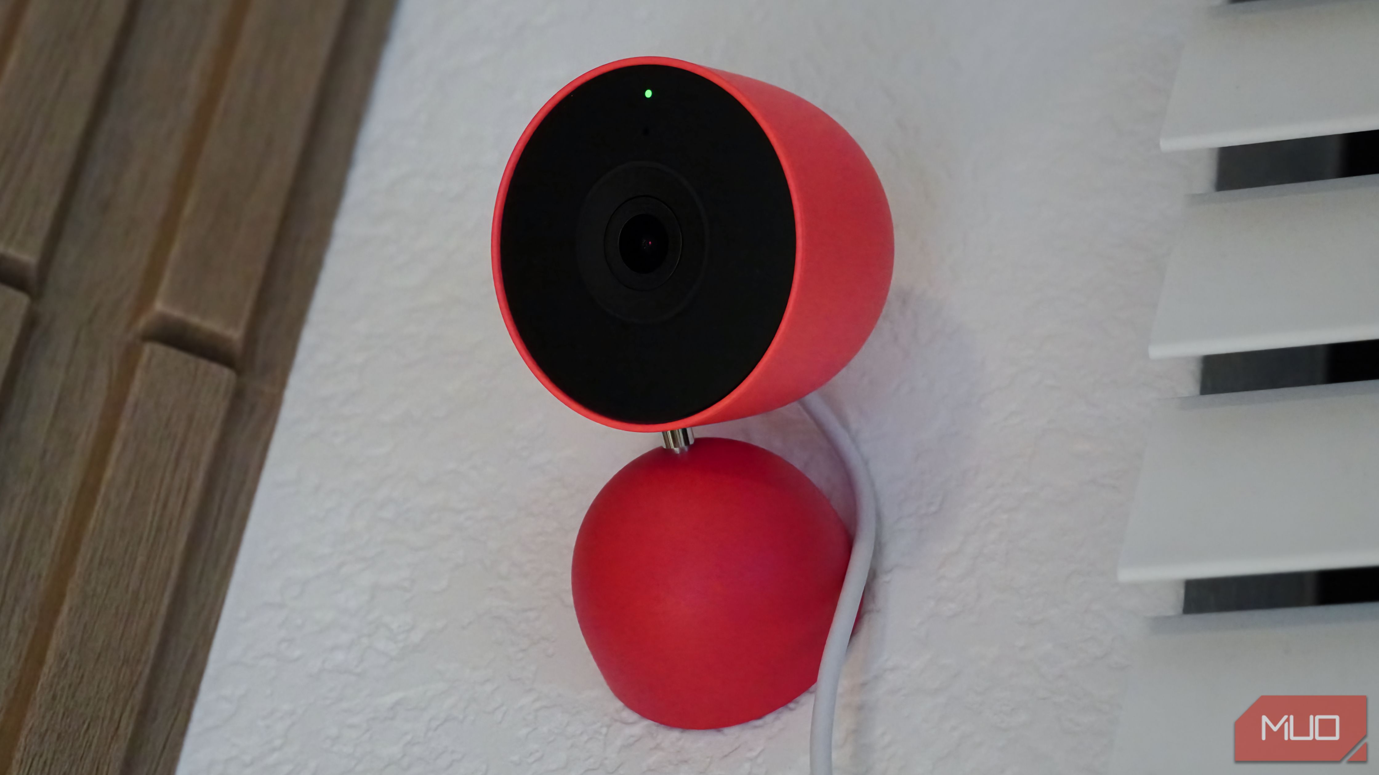 The Google Nest Cam Indoor Gen 3 mounted on the wall with the camera LED on.