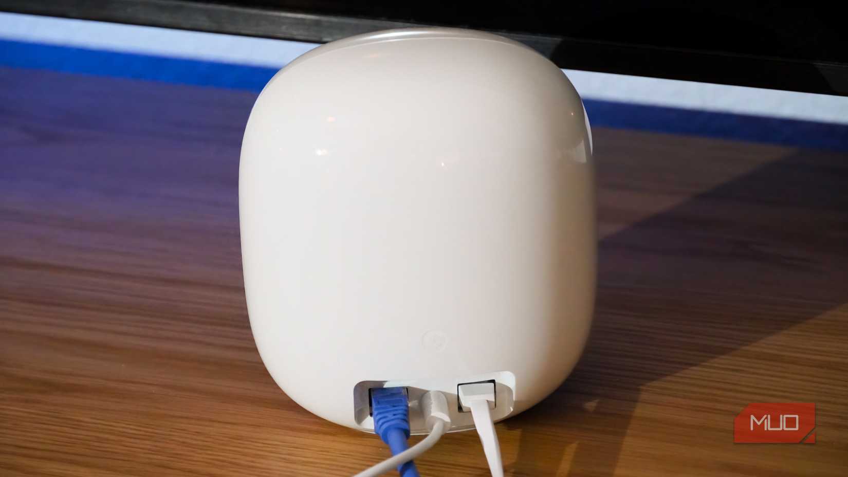 Ethernet and power cables plugged into the Nest Wi-Fi Pro.
