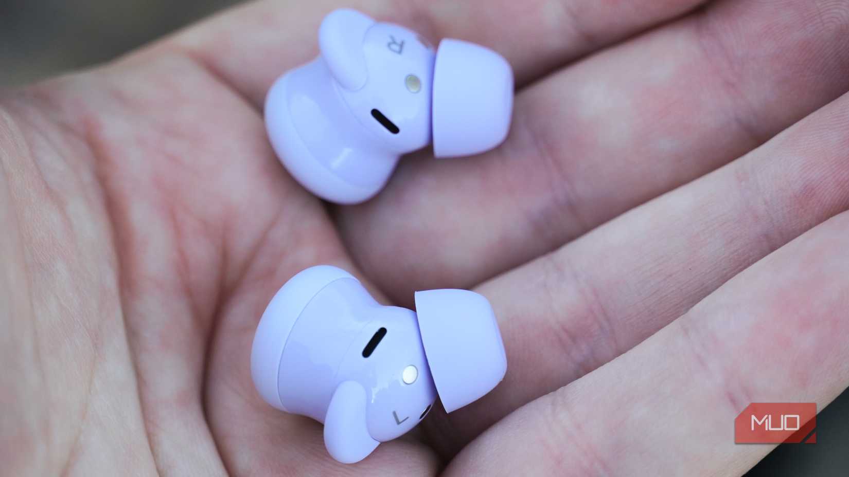 Purple Google Pixel Buds 2a earbuds in the hand.