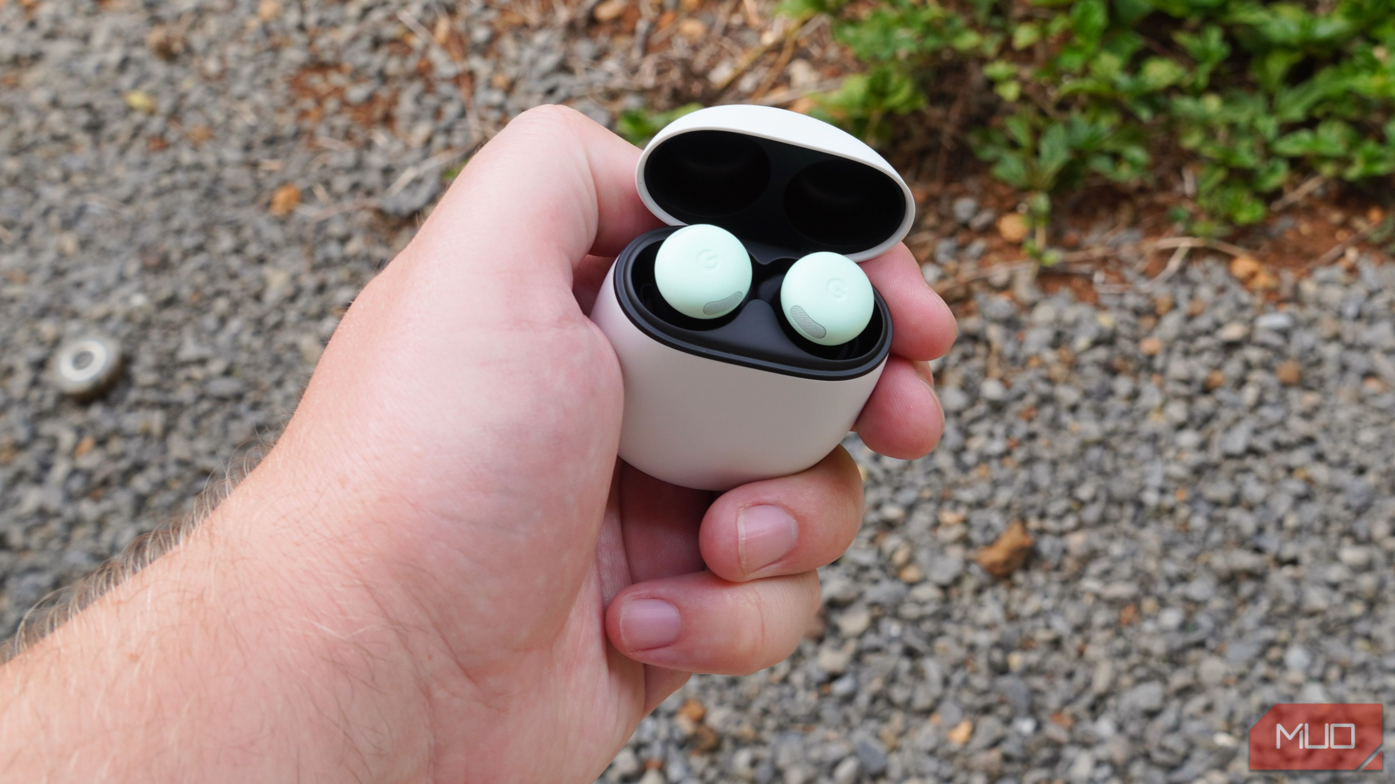Google Pixel Buds Pro 2 with the case opened in the hand.