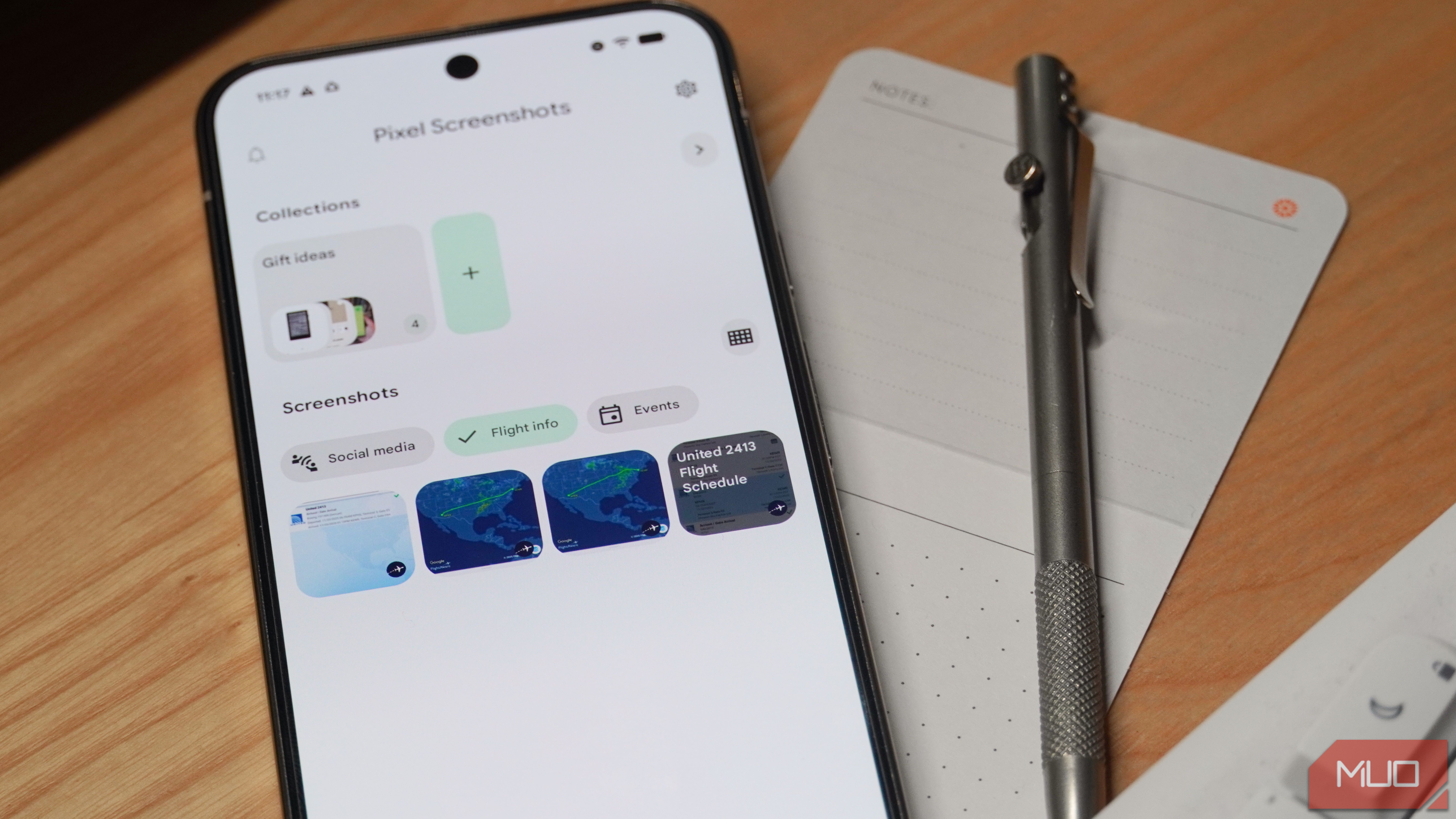 Pixel Screenshots beside a notecard and pen.