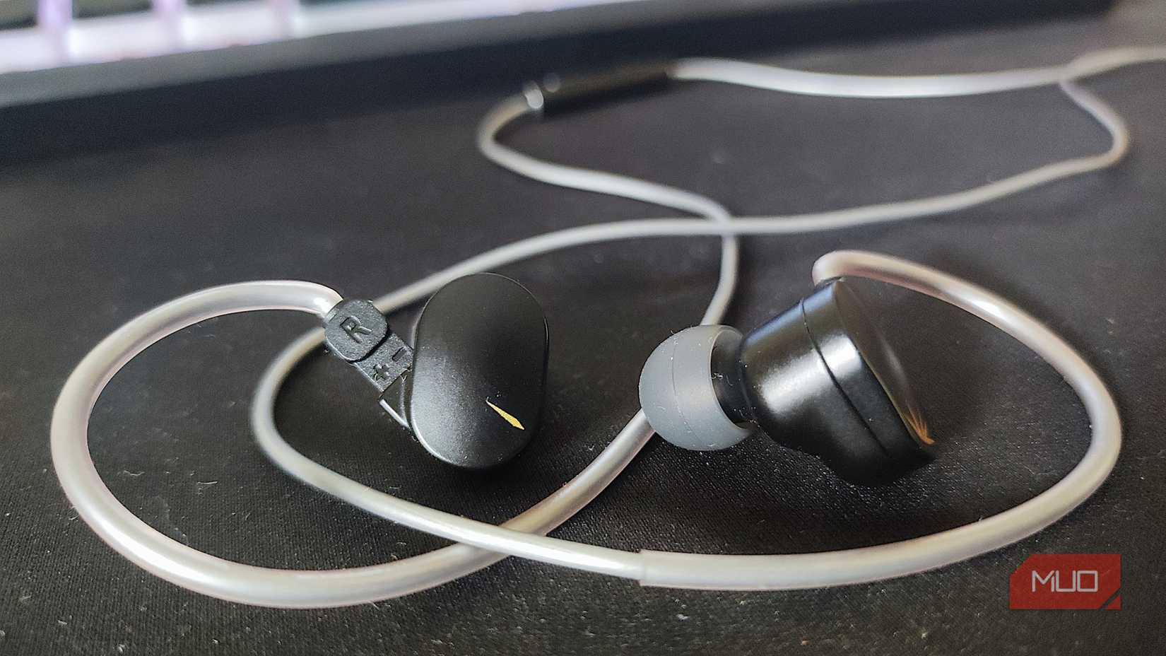 Moondrop chu 2 DSP on a black mousepad with eartips on.