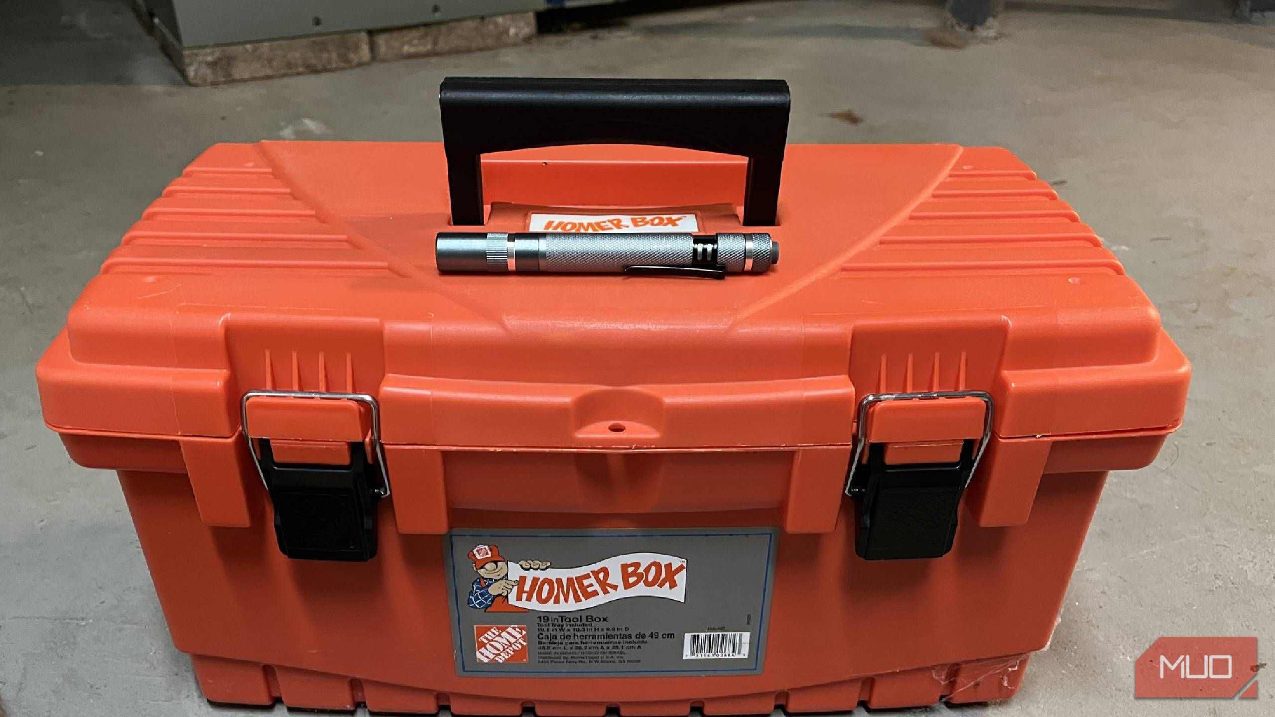 A penlight on top of a closed toolbox