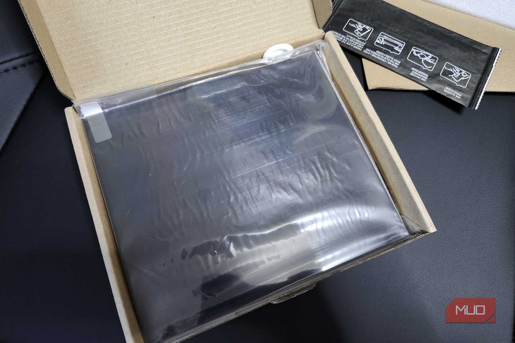 The Polarizing Film inside of a box, wrapped in plastic with an alcohol pad and finger protection for applying