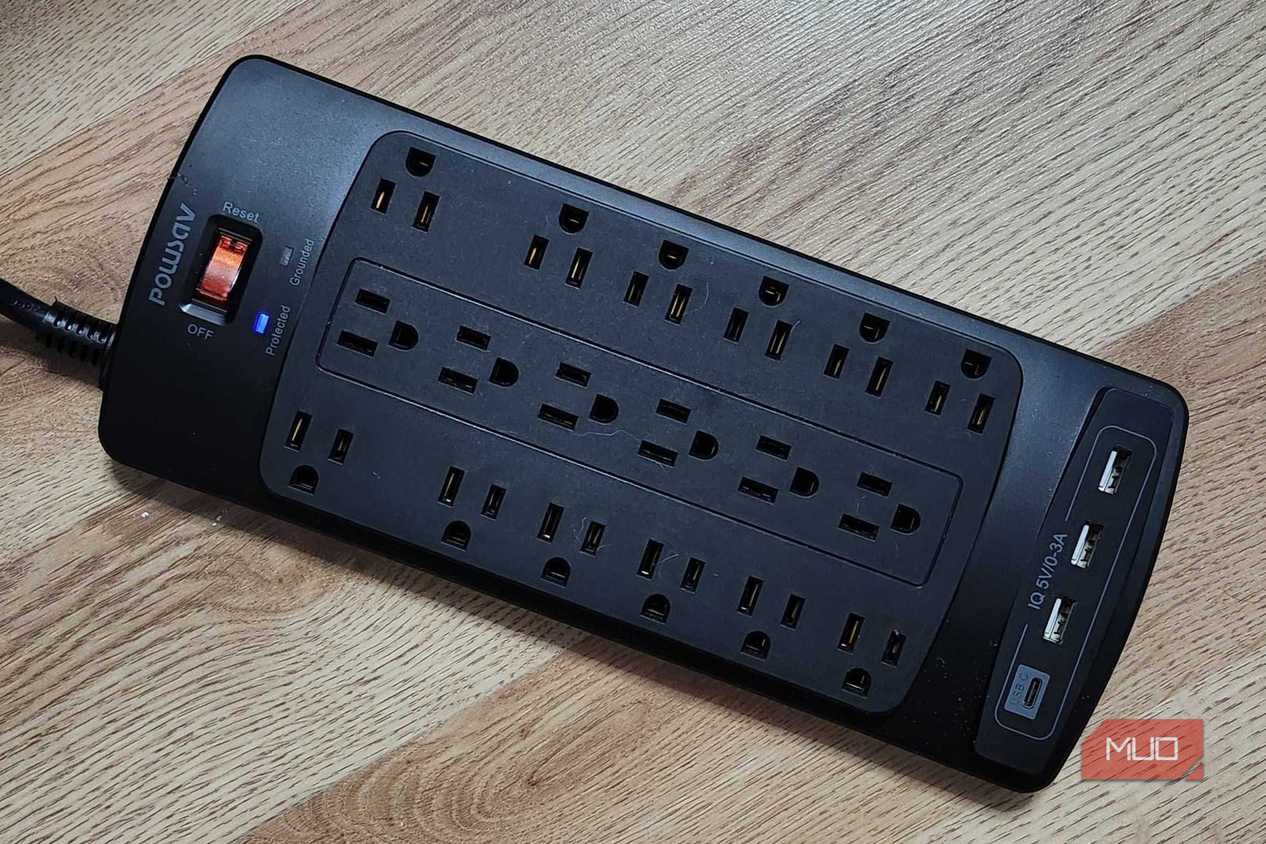 The Powsav 18-Plug Surge Protector, plugged in with one glowing light