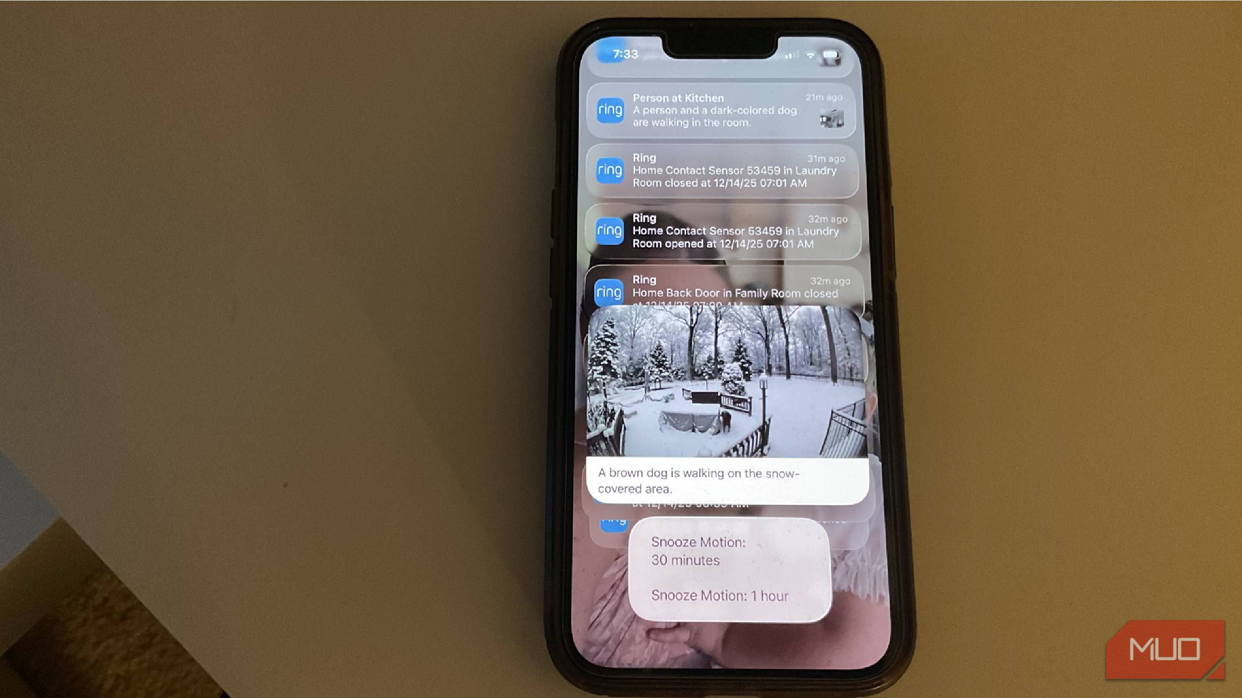 A phone on a desk showing Ring AI Video Descriptions