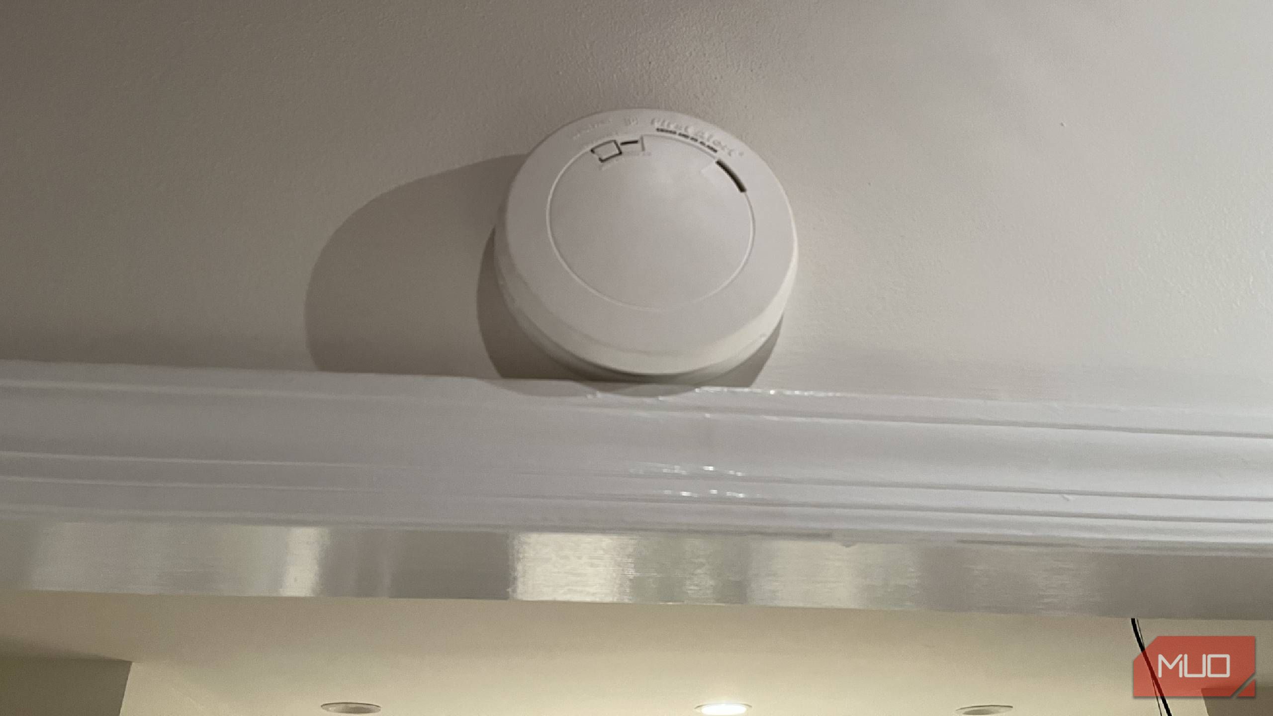 A smoke alarm above a doorway