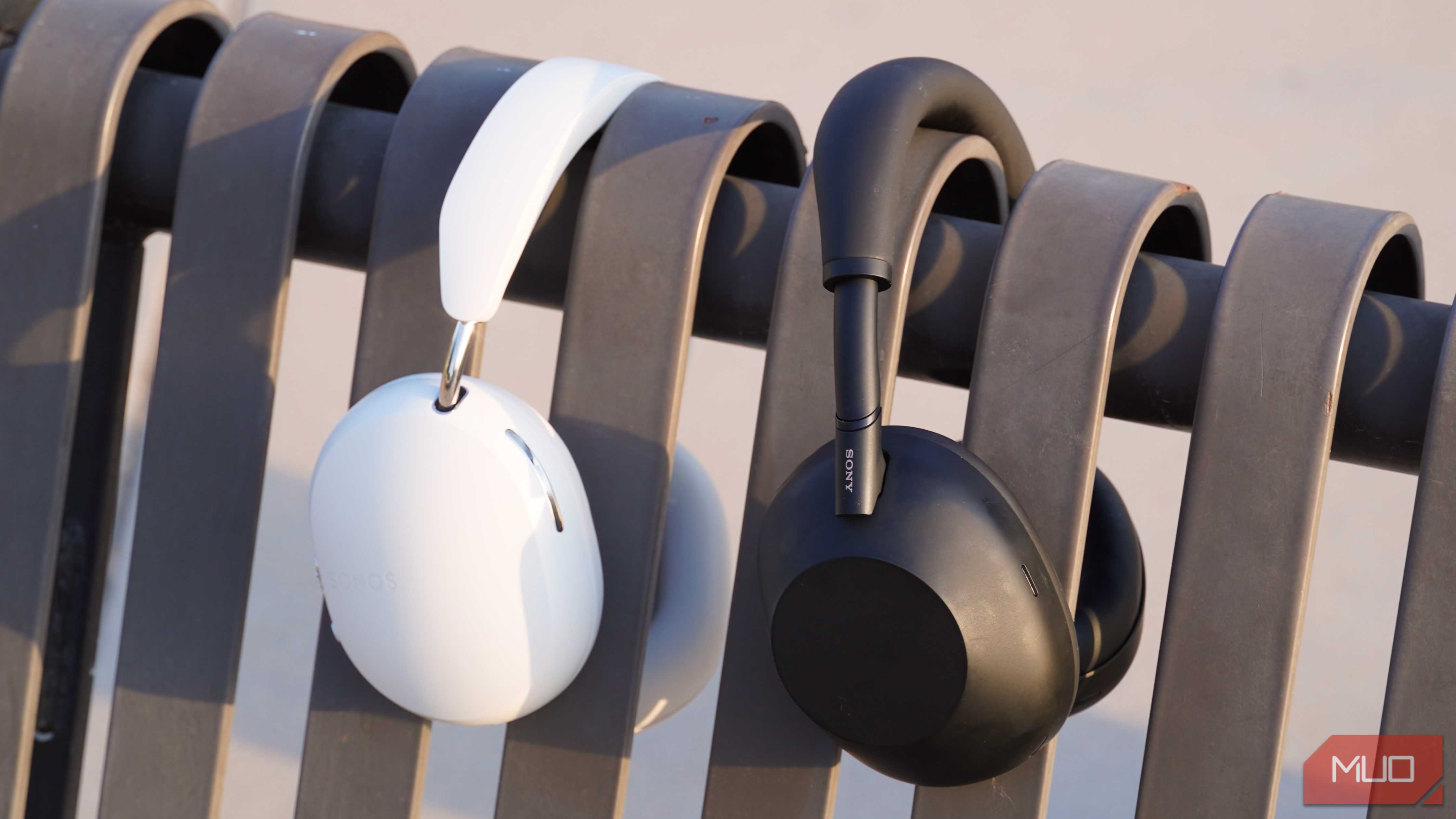 The Sonos Ace and Sony WH-1000XM6 on a park bench.