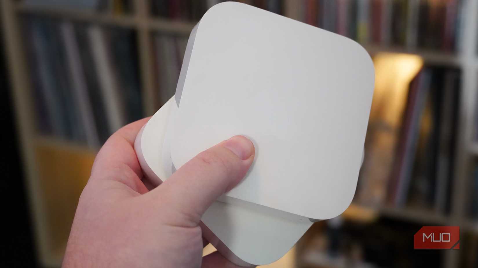 Holding multiple AirPort Express in my hand.