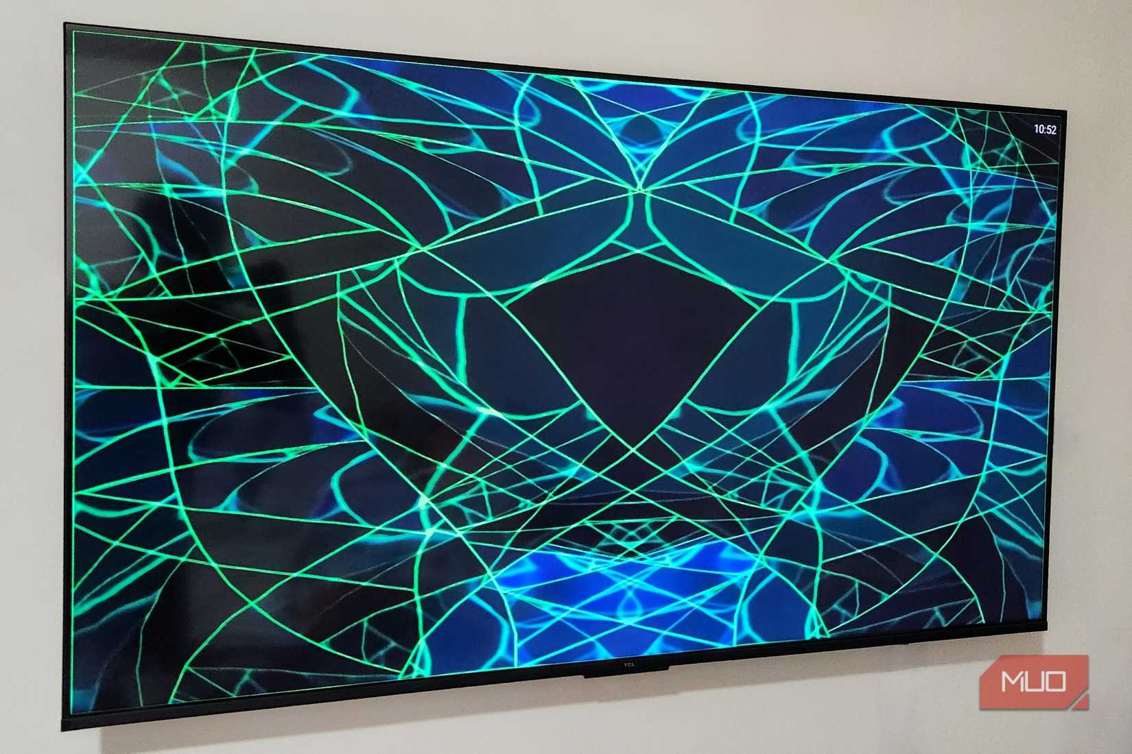 TV on a wall showing music visualizer