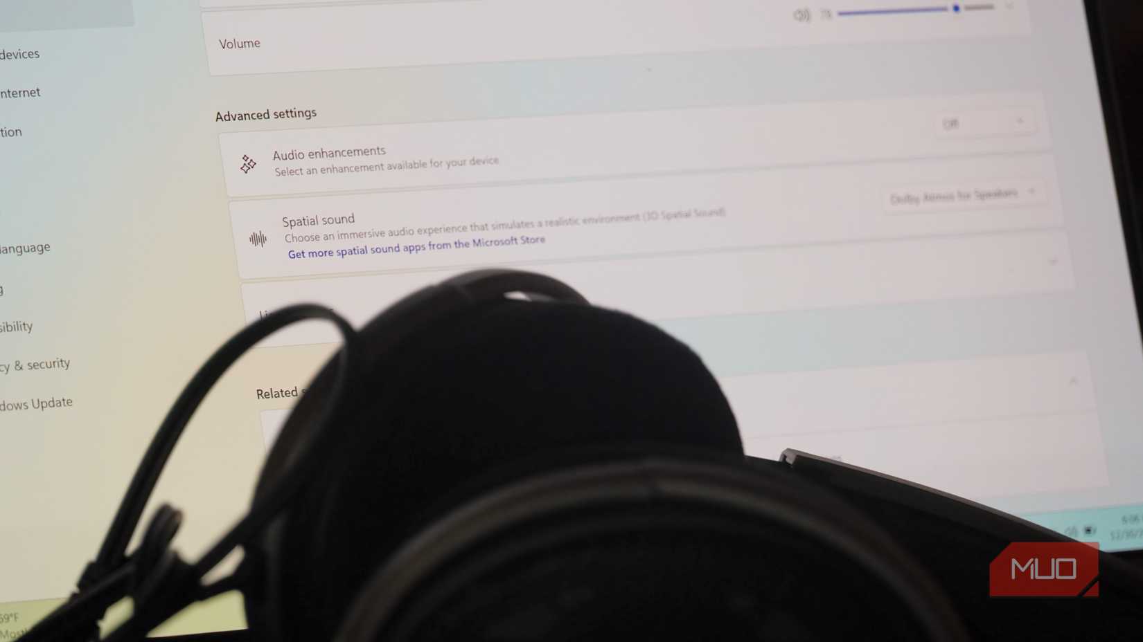 Audio enhancement settings behind a pair of over-ear headphones.