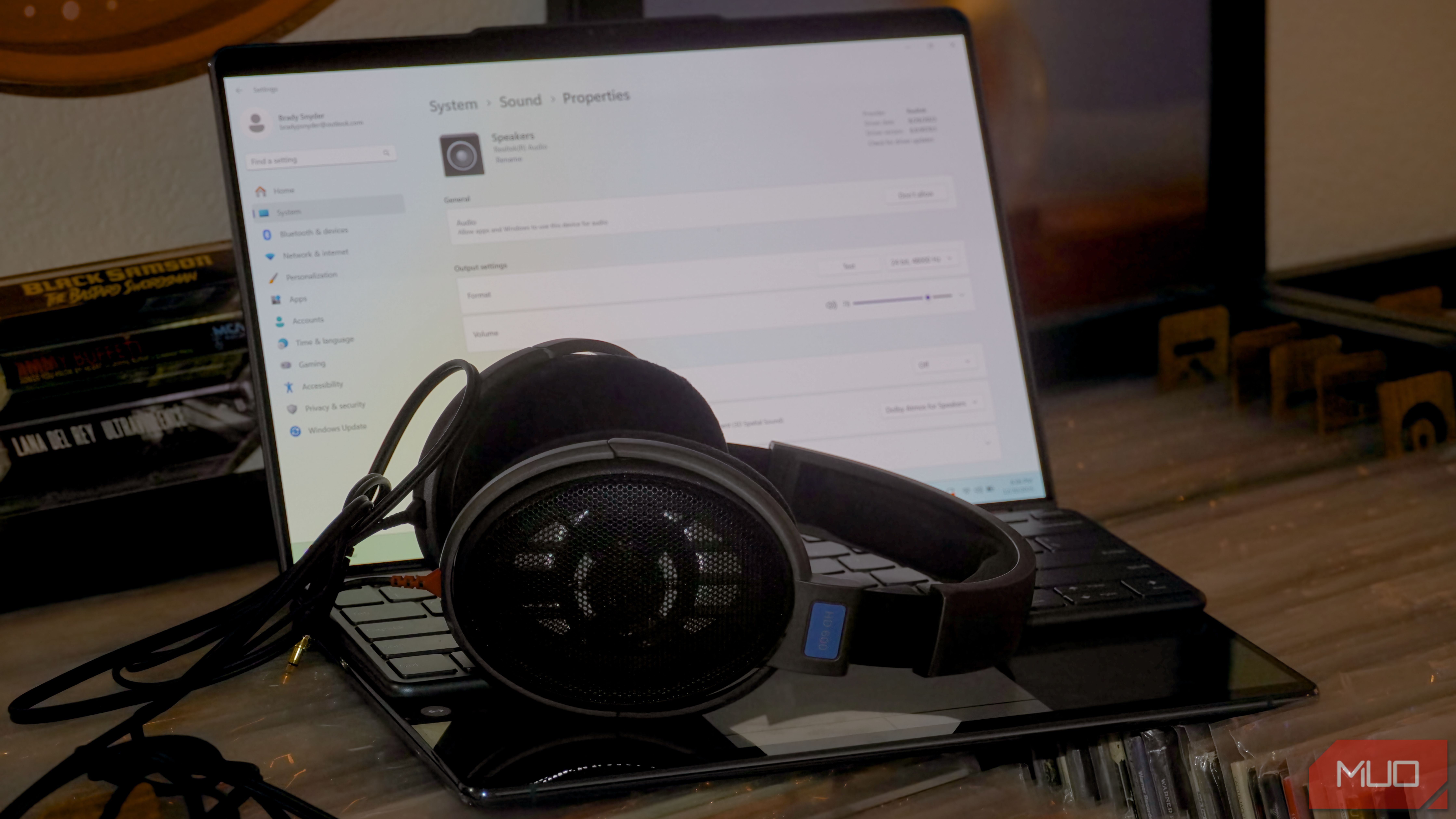 Windows 11 audio settings open with a pair of Sennheiser HD600 headphones on the keyboard.