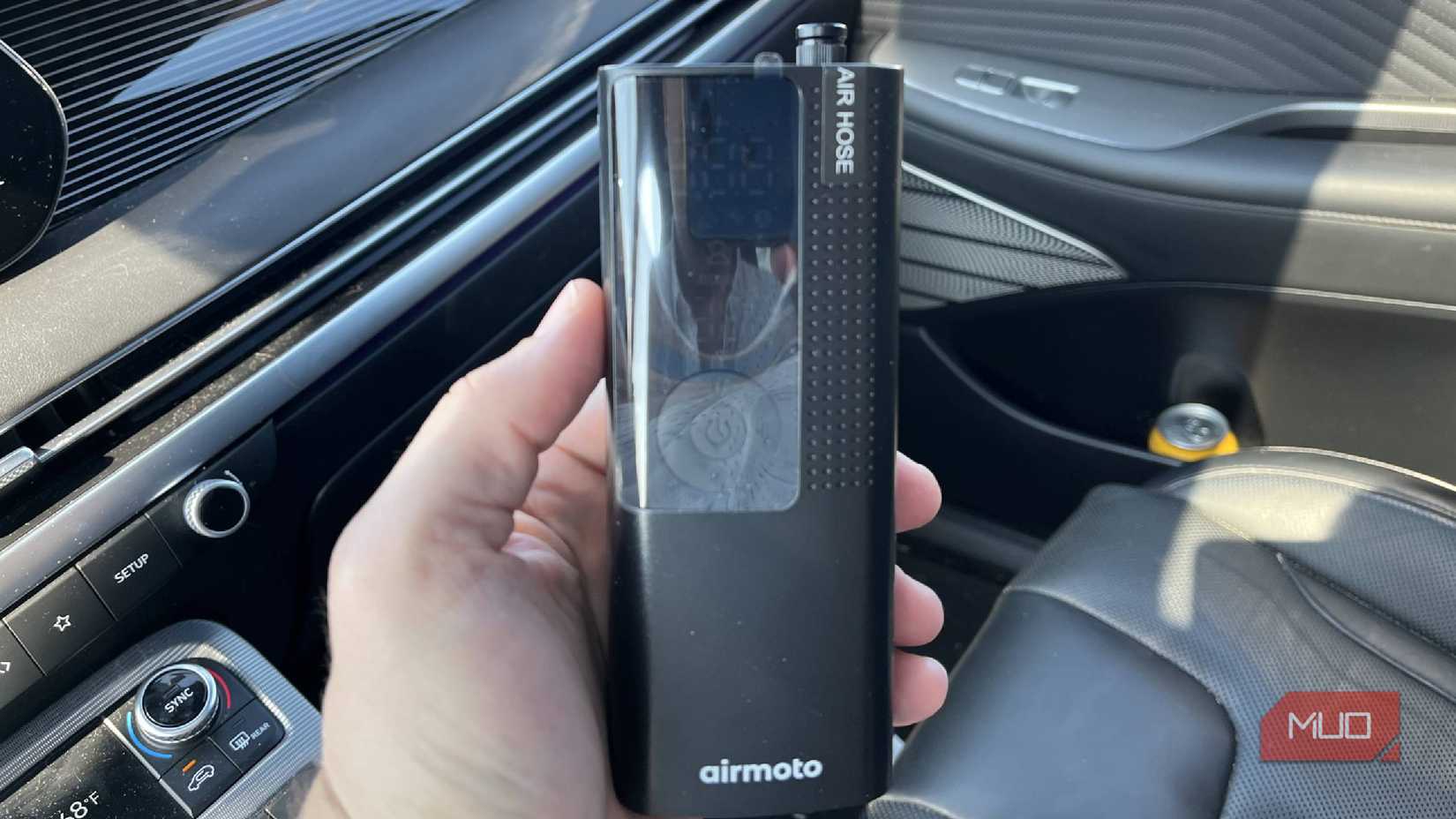 The Airmoto tire pump in a car