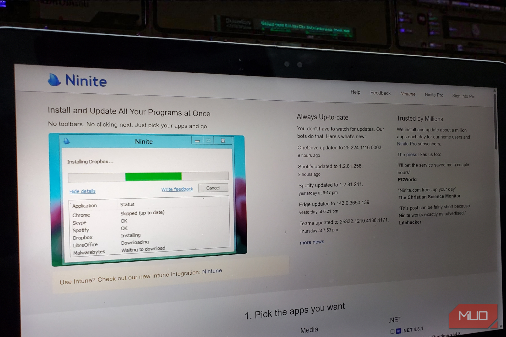 A laptop screen displaying the Ninite website homepage with a list of downloadable applications and a Get Your Ninite button.-1