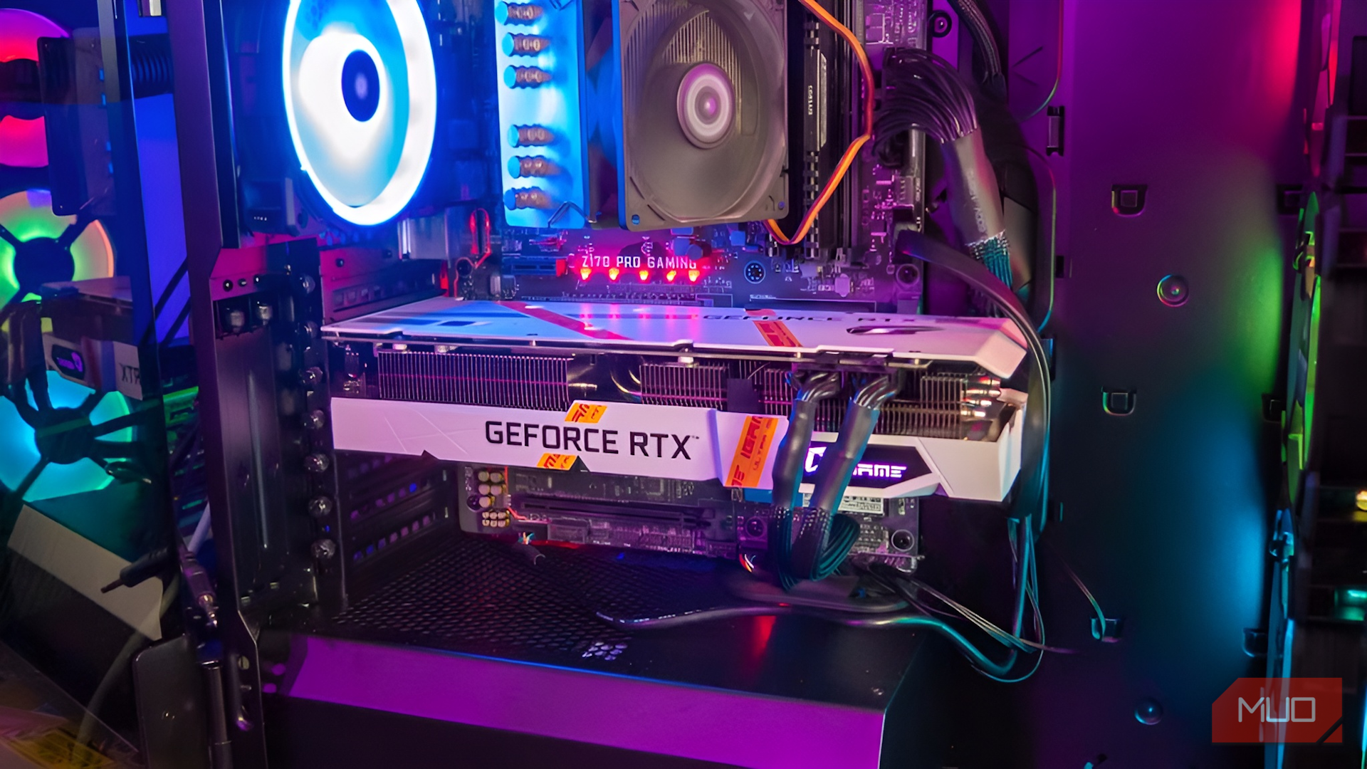 A white iGame GeForce RTX graphics card installed inside a gaming PC case with RGB lighting.