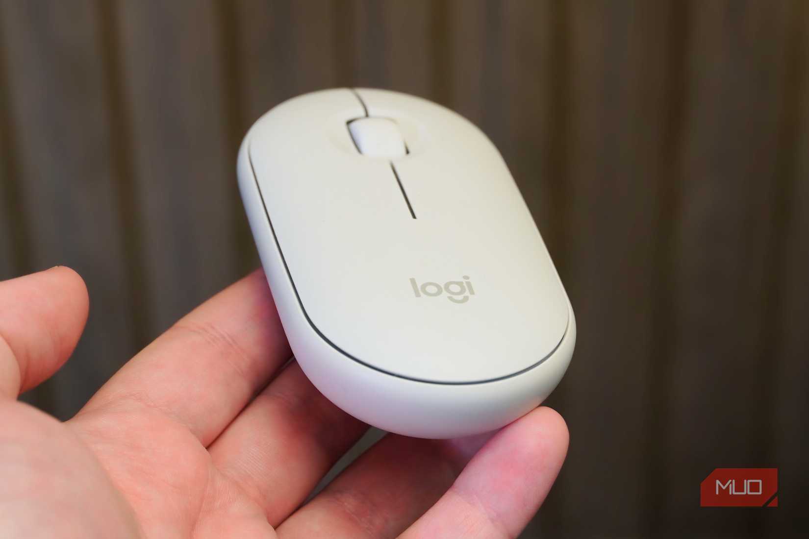 Balancing the Logitech Pebble Mouse 2 in the hand.