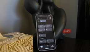An Android phone propped up on a side table showing a smart home control menu.