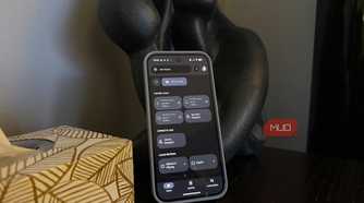An Android phone propped up on a side table showing a smart home control menu.