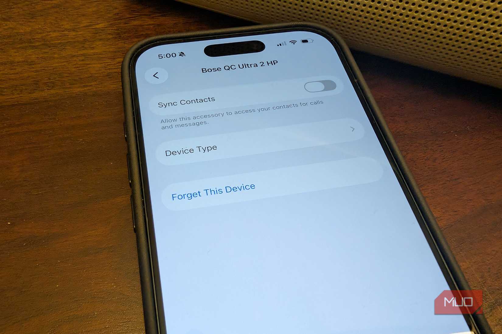 An iPhone showing a Bluetooth connection and forget this device.