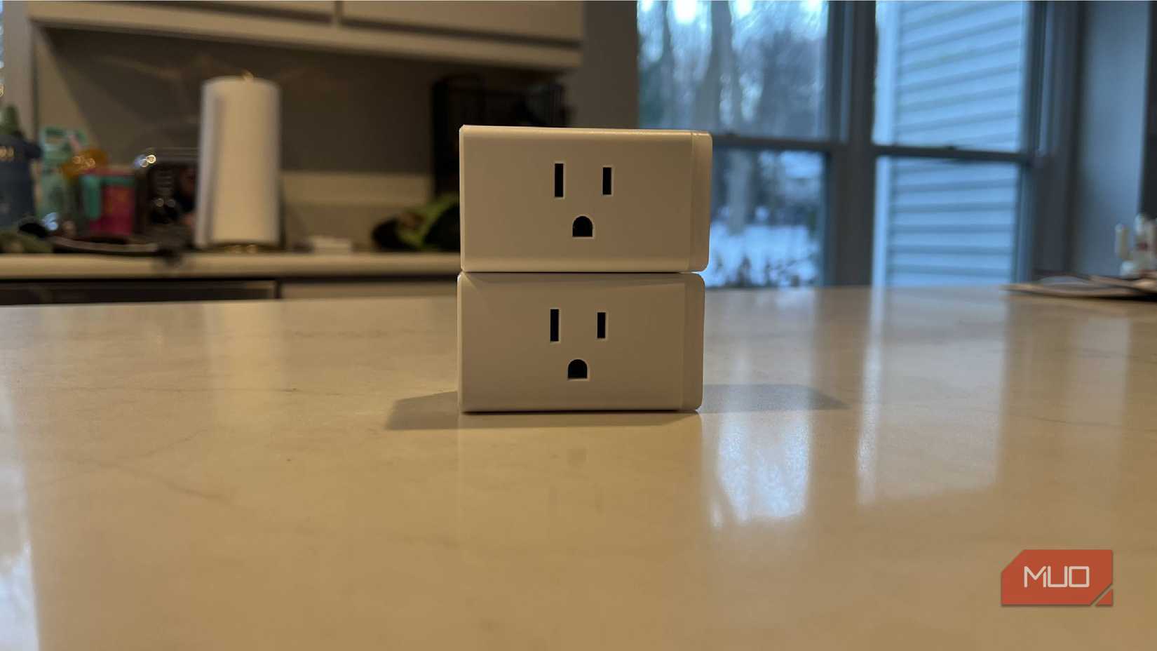 Two Kasa smart plugs stacked on top of one another