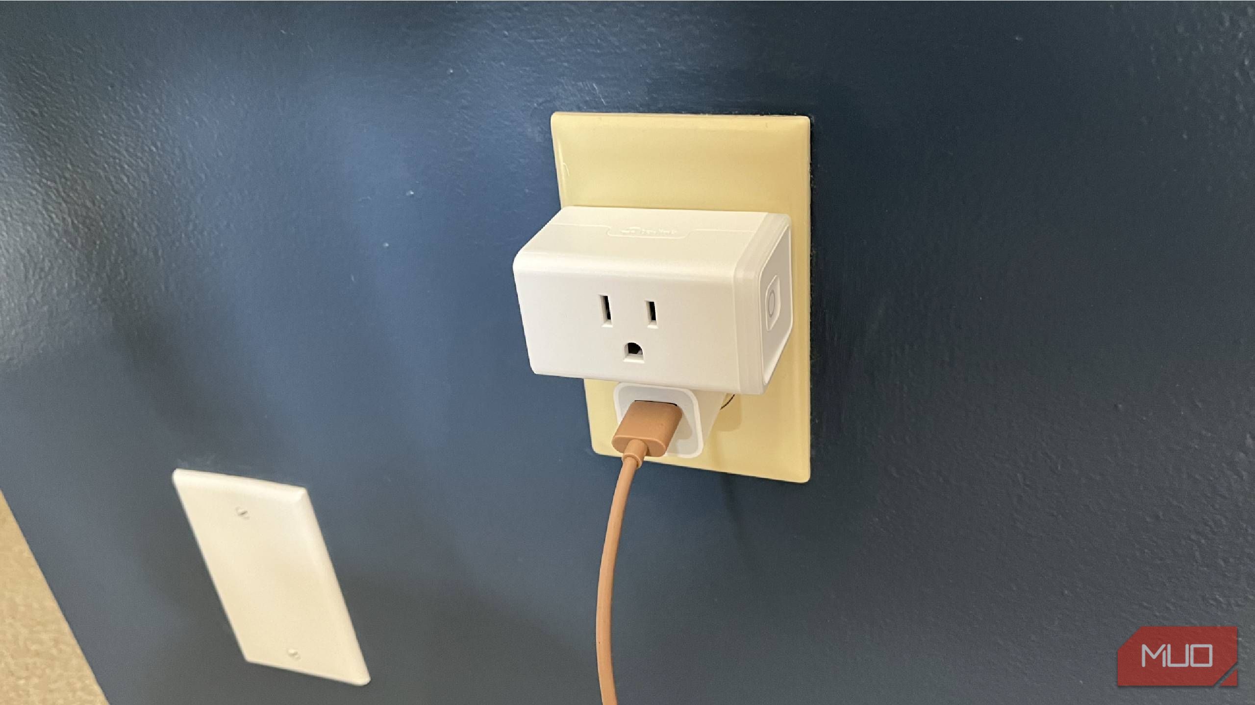 A Kasa smart plug into a wall outlet