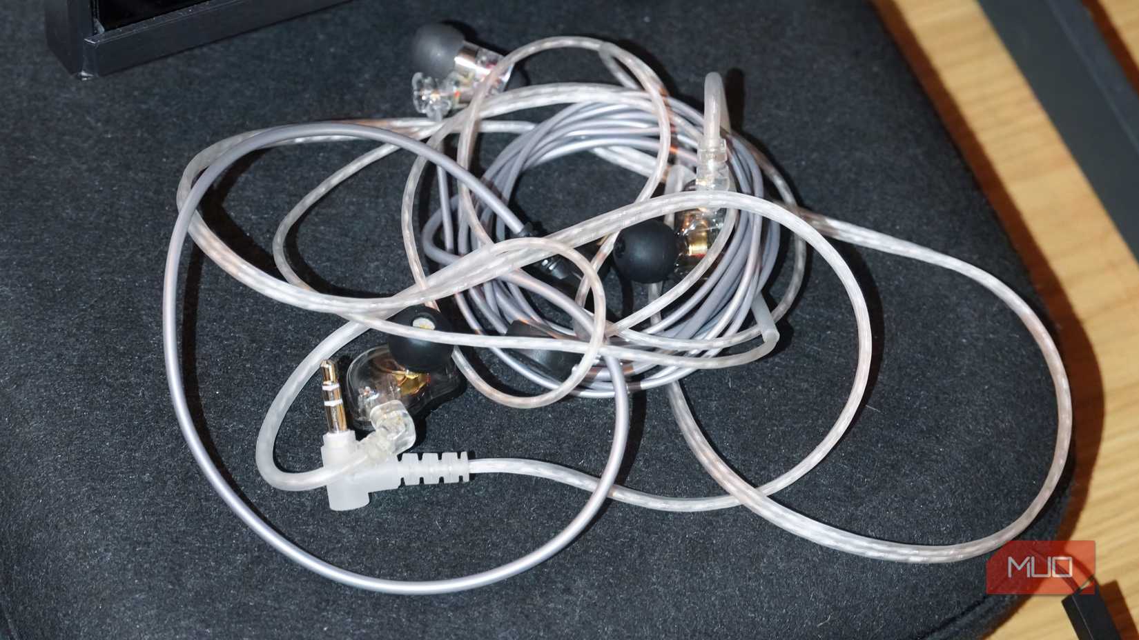 A pile of "Chi-Fi" IEMs on a black felt case.