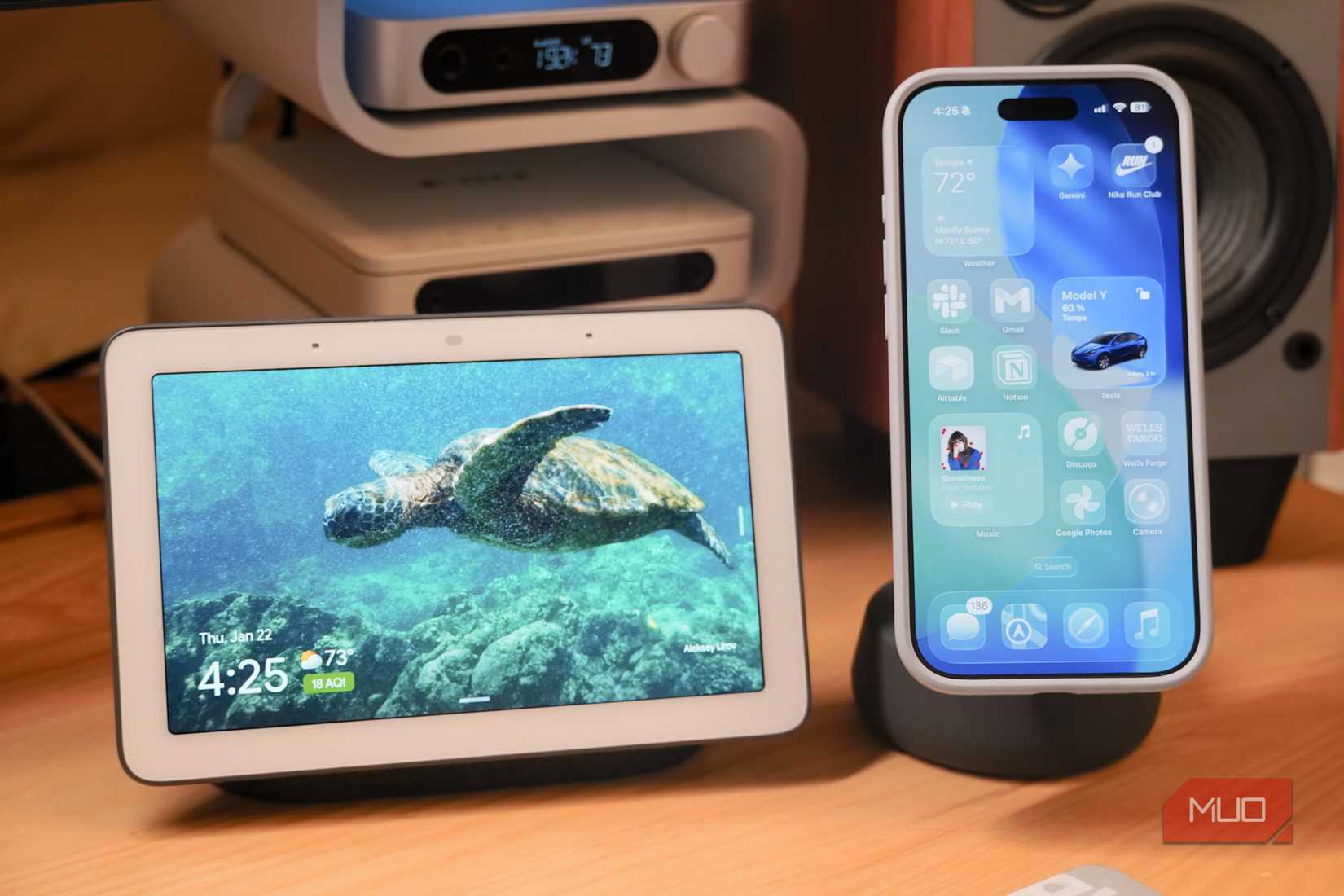 A Google Nest Hub beside an iPhone on a MagSafe charger.