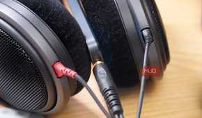 A pair of Sennheiser over-ears connected to a TCL 60 XE NXTPAPER.