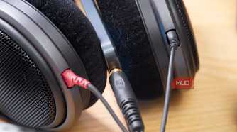 A pair of Sennheiser over-ears connected to a TCL 60 XE NXTPAPER.