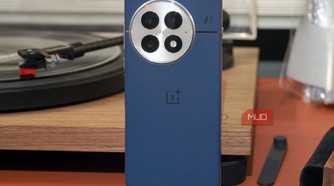 The OnePlus 13 in blue leaning against a vinyl record player.