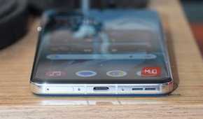 The OnePlus 13 USB-C port and SIM tray.