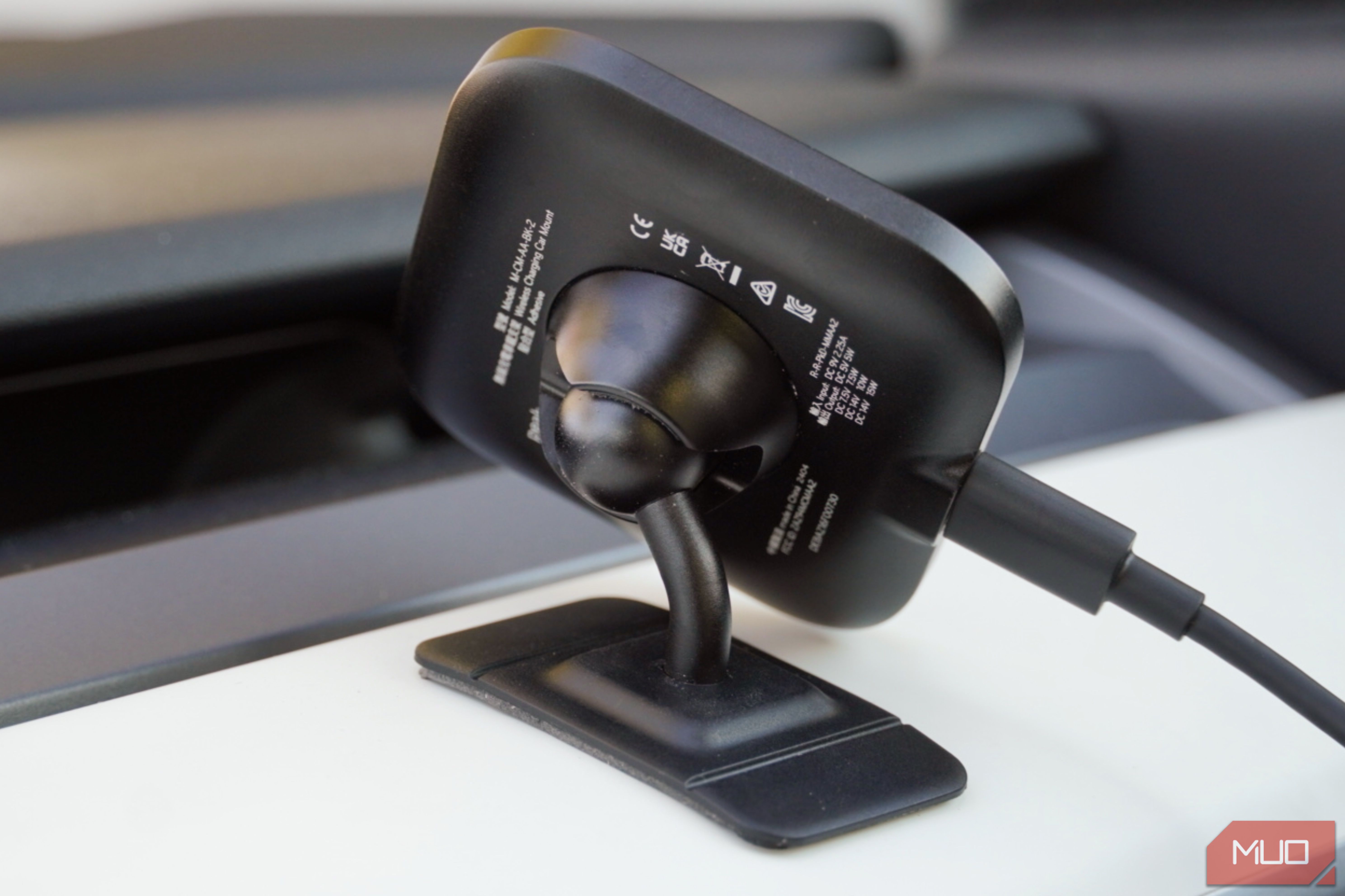 The ballhead mount of a Peak Design Qi2 car charger.