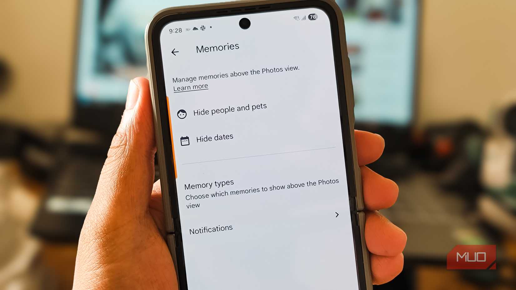Person holding a Samsung Galaxy Z Flip 6 with the Google Photos app open