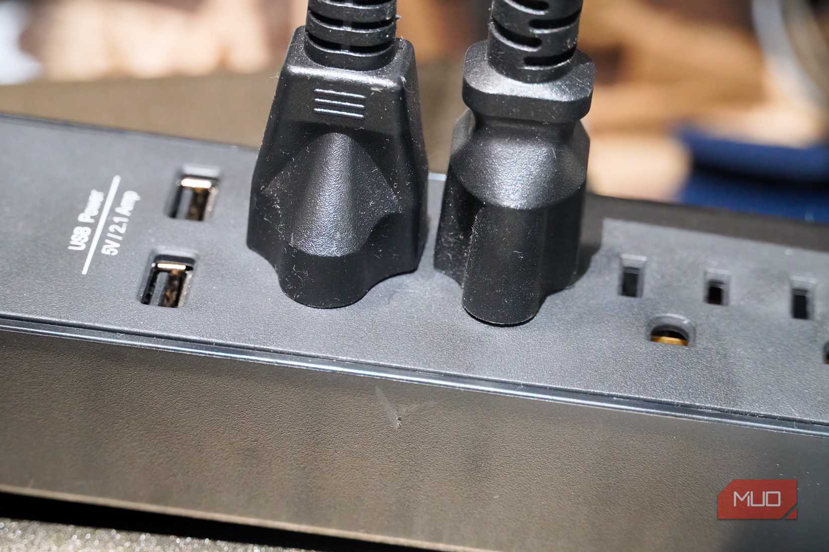 Large plugs in a power strip next to USB-A ports.