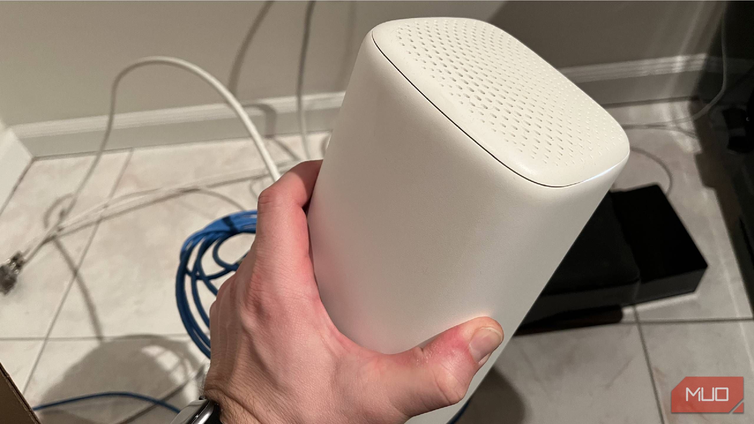 The top and side of a Wi-Fi router being held