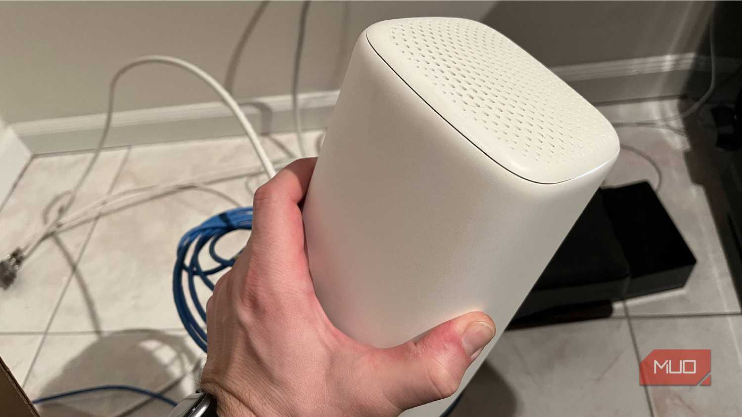 The top and side of a Wi-Fi router being held