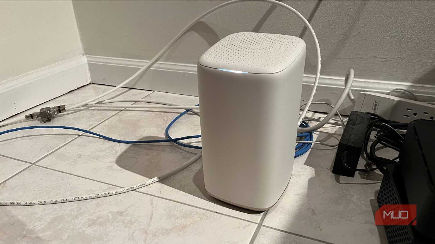 A Wi-Fi router on a tile floor