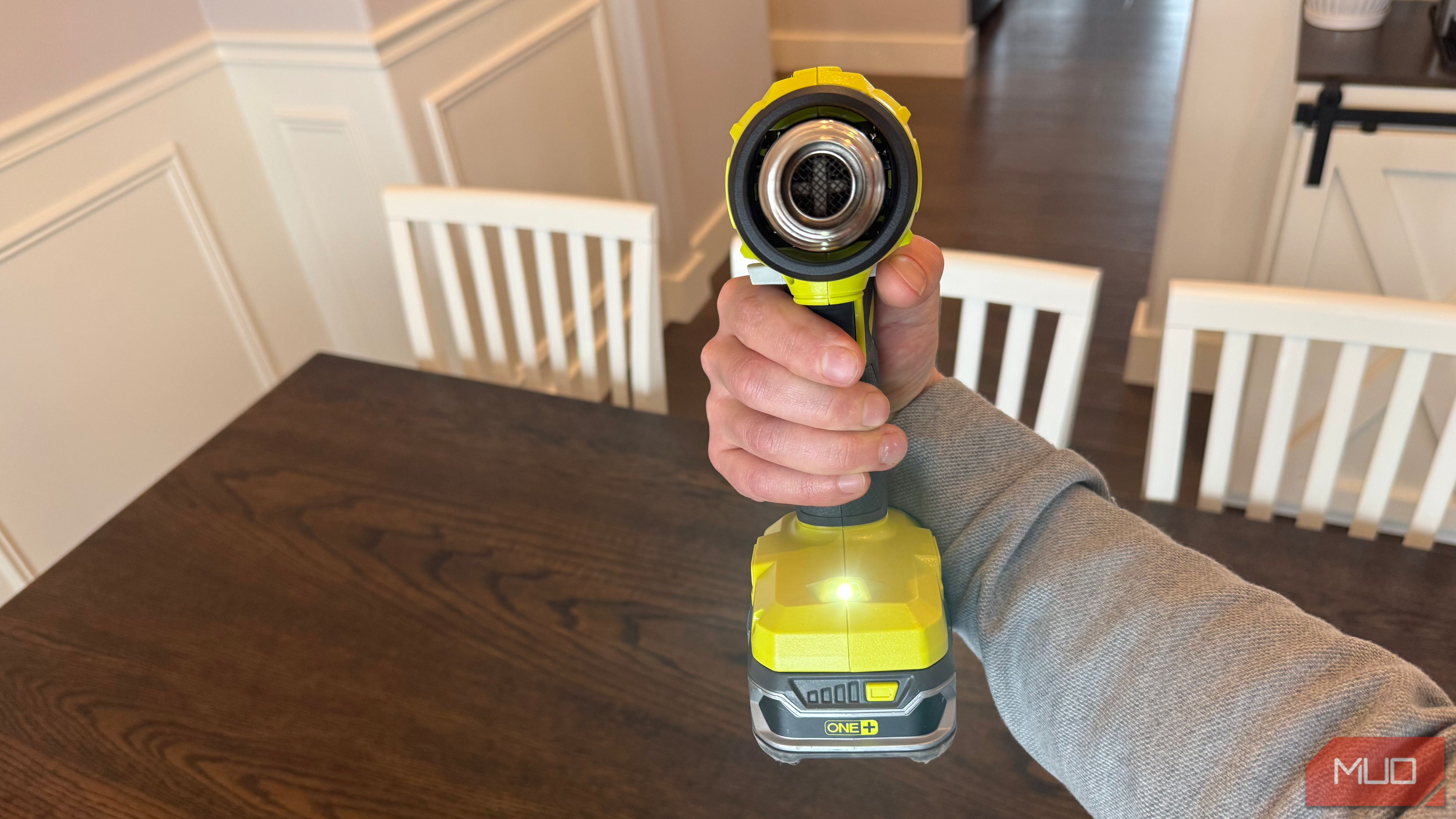 ryobi heat gun in hand with trigger depressed