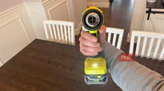 ryobi heat gun in hand with trigger depressed