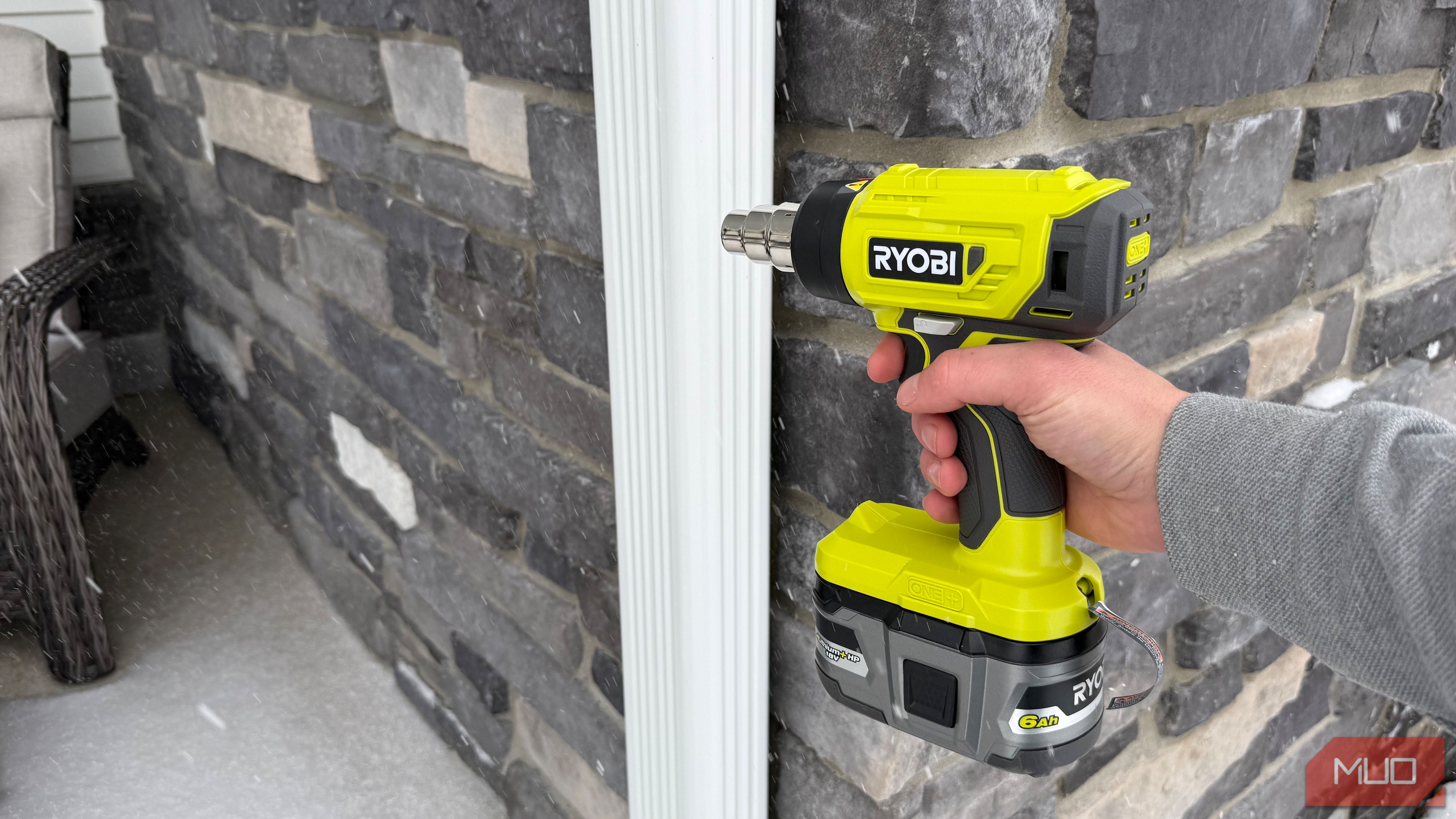 ryobi heat gun pointing at downspout