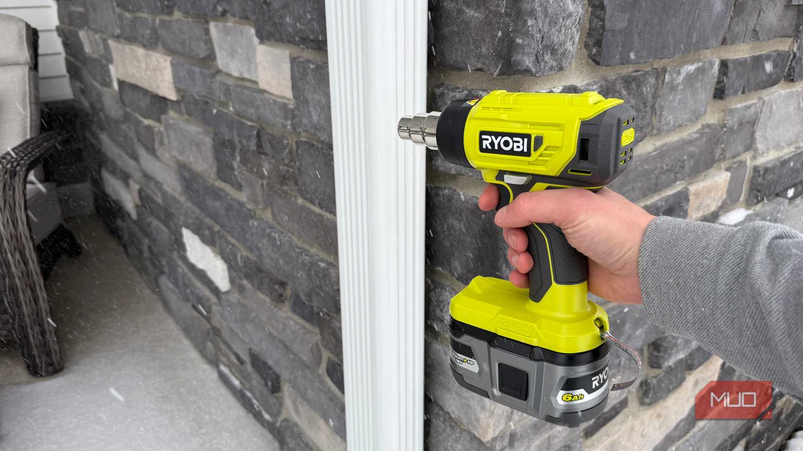ryobi heat gun pointing at downspout