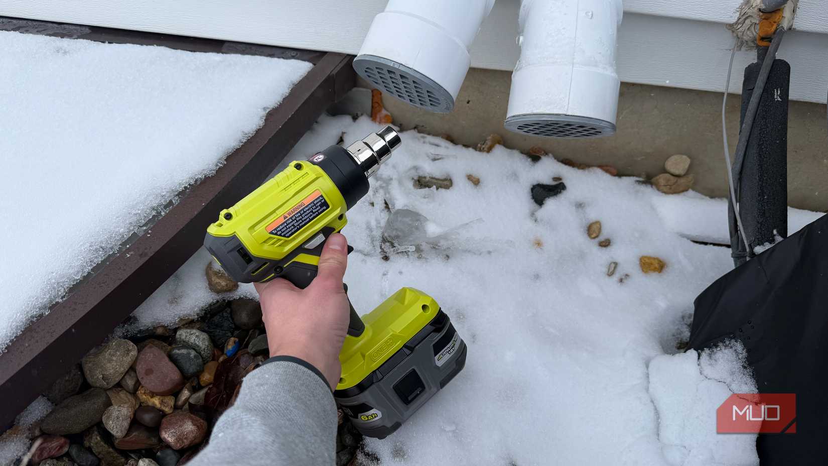 ryobi heat gun pointing at furnace exhaust