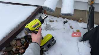 ryobi heat gun pointing at furnace exhaust