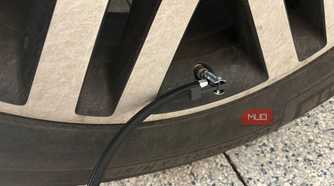 ryobi tire inflator hose connected to valve stem