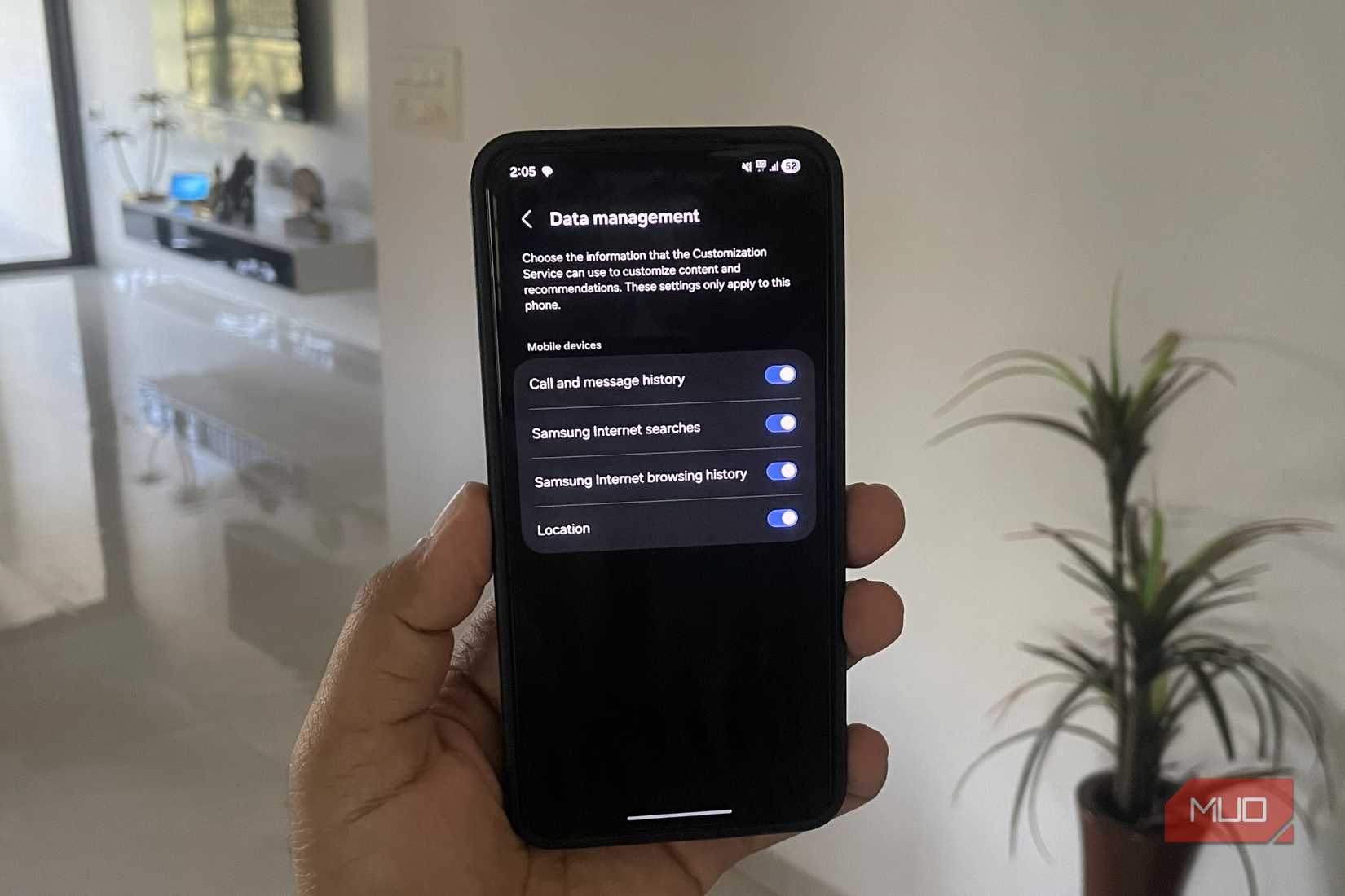 Samsung phone in hand showing data management menu