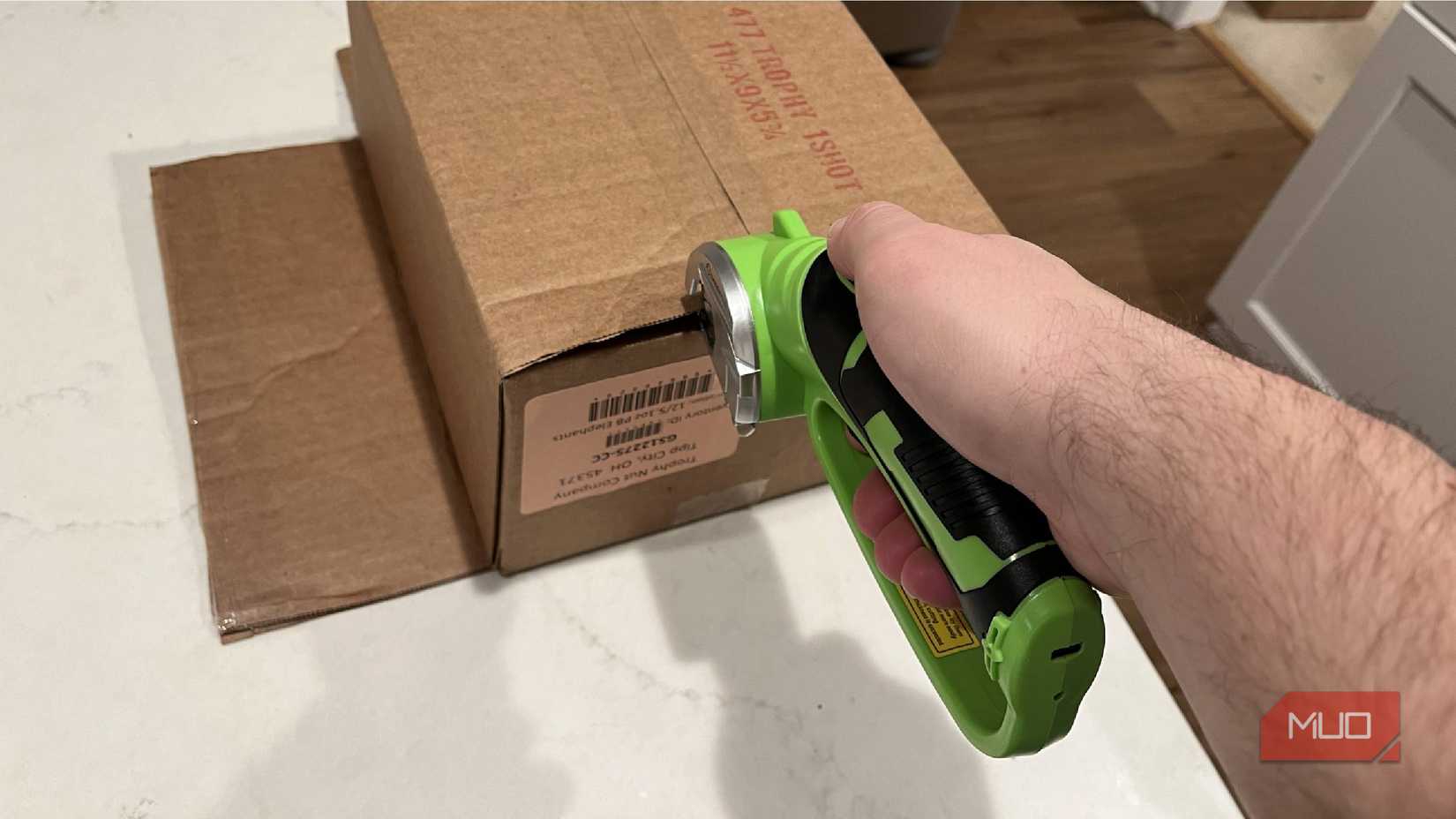 Saker Plus Cordless Electric Scissors being used to cut a box