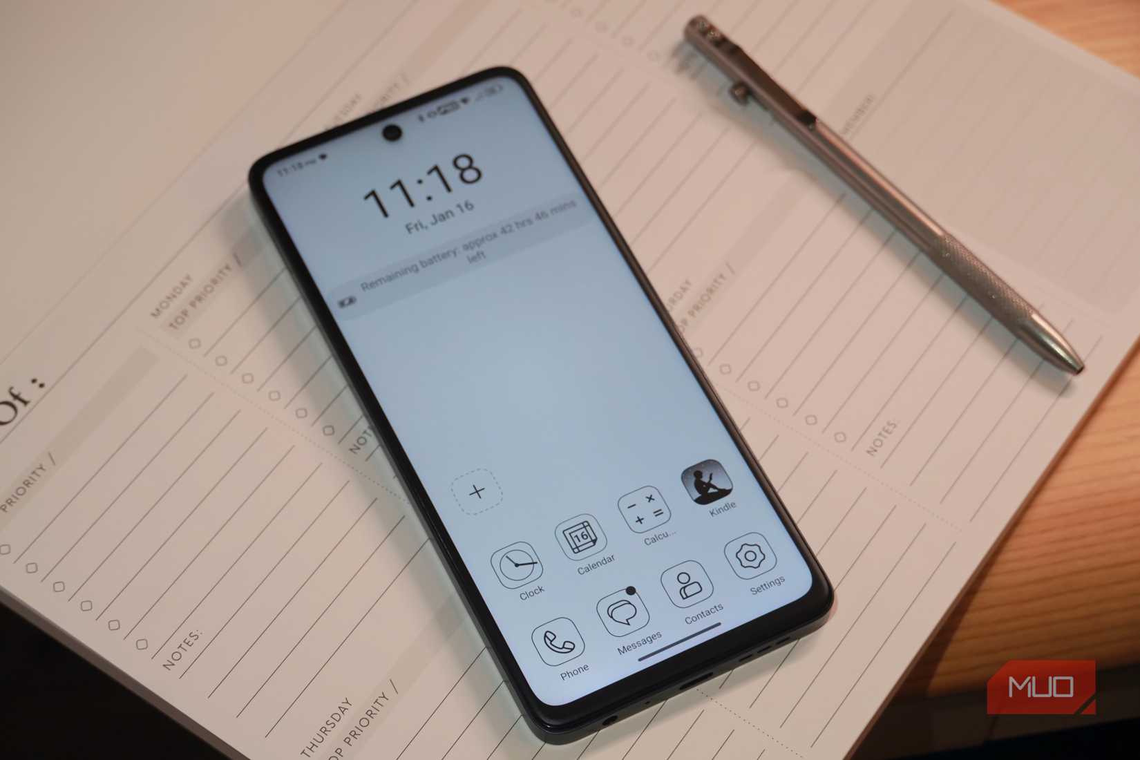 The TCL 60 XE NXTPAPER 5G on a notepad in MAX INK mode.