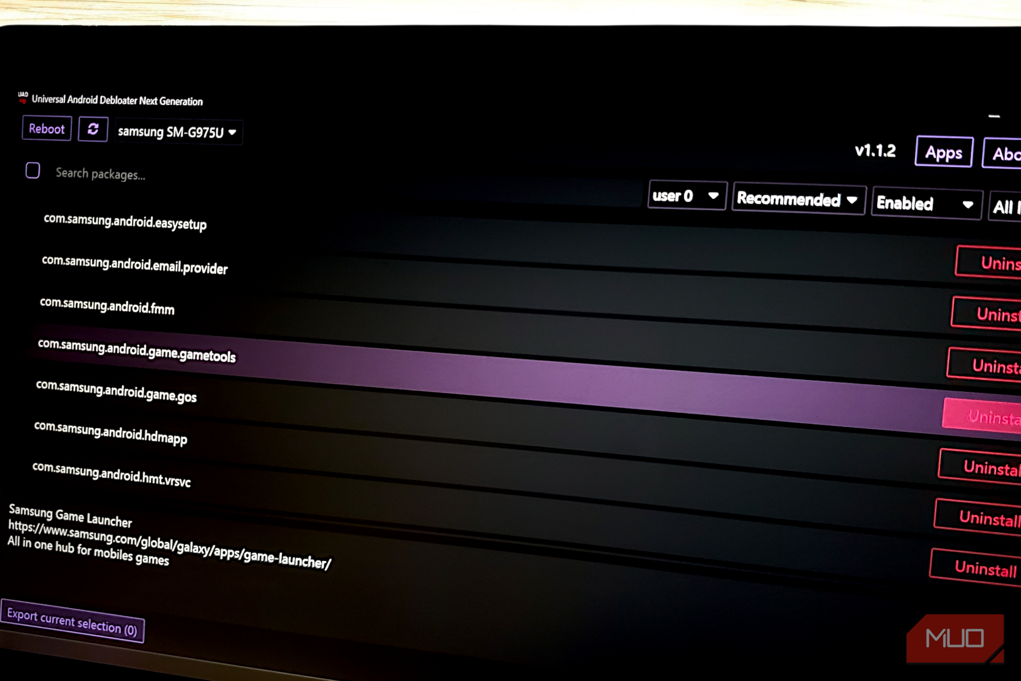 The Universal Android Debloater Next Generation app interface on a laptop, listing Samsung packages.